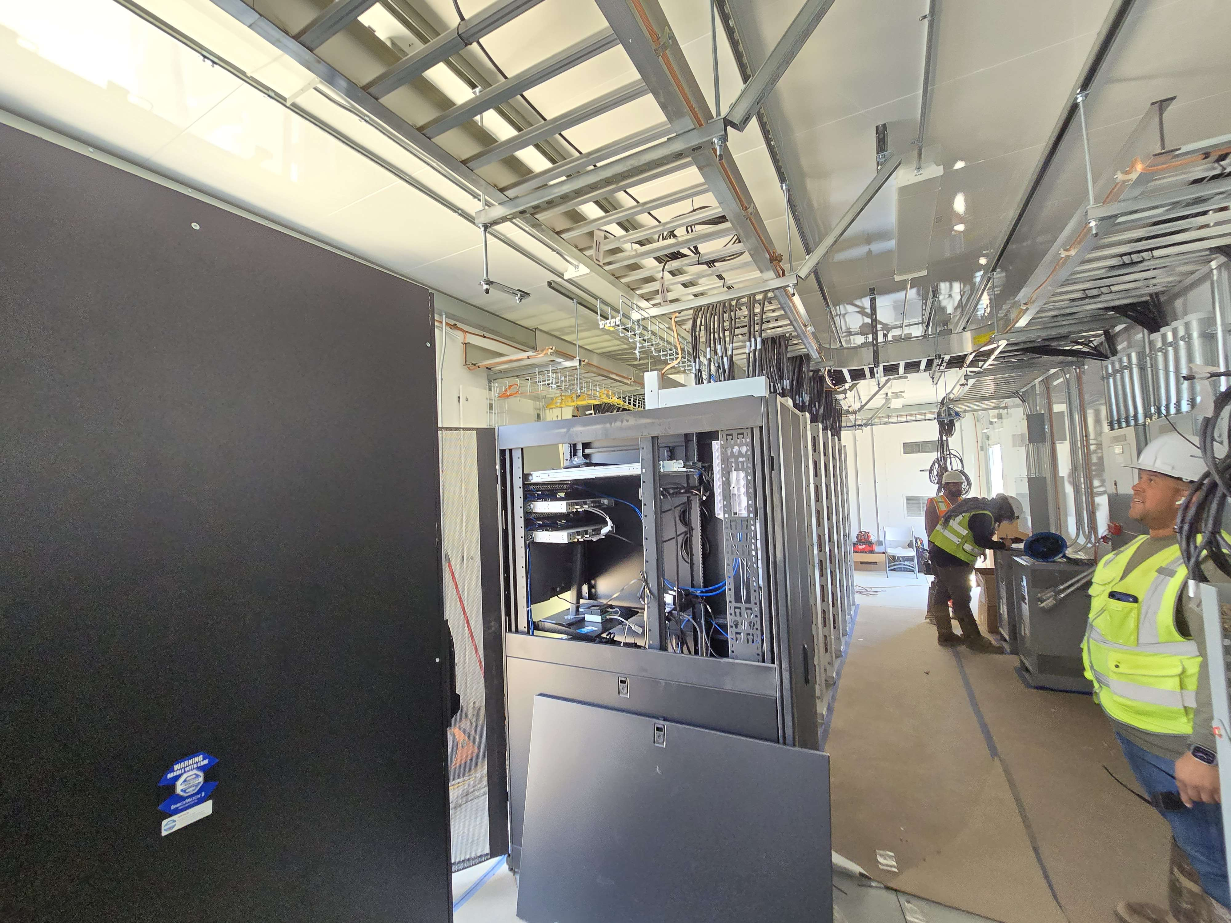 Sabino WiFi network buildout with server racks and overhead cable tray